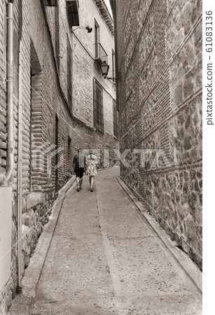 lovers man and woman go through the narrow street lovers man and woman go through the narrow street 61083136