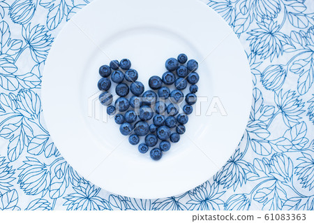 blueberries in a heart shape on a white plate blueberries in a heart shape on a white plate 61083363
