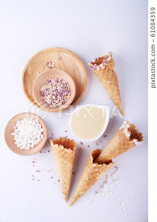 empty ice cream cones with colourful sprinkles empty ice cream cones with colourful sprinkles 61084359