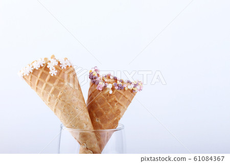 empty ice cream cones with colourful sprinkles empty ice cream cones with colourful sprinkles 61084367
