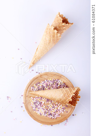 empty ice cream cones with colourful sprinkles empty ice cream cones with colourful sprinkles 61084371