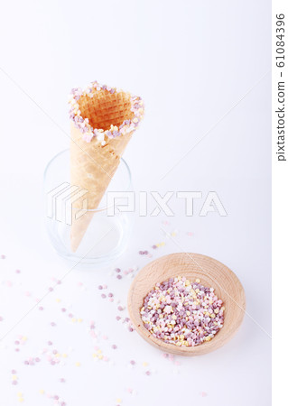 empty ice cream cones with colorful sprinkles 61084396