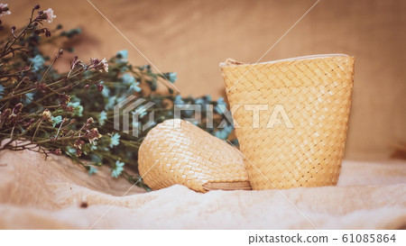 Set of Empty wicker basket on the table with background in natural linen and green plant,Template mock up for display of product 61085864