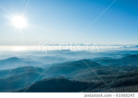An aerial view of the forest and mountains with an open sky An aerial view of the forest and mountains with an open sky 61088245