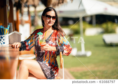 Attractive woman is enjoying her drink at the bar in her holiday 61088797