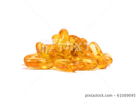 A pile of yellow collered medicine on a white background A pile of yellow collered medicine on a white background 61089095