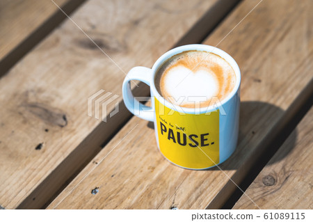 A tasty cup of coffee on a wooden table A tasty cup of coffee on a wooden table 61089115