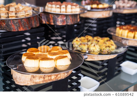 A delicious dessert buffet with various sweet bakery in a restaurant or hotel A delicious dessert buffet with various sweet bakery in a restaurant or hotel 61089542