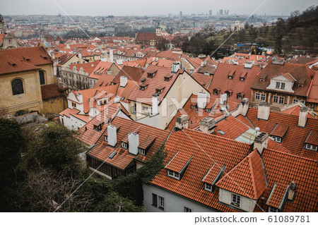City of Prague with red roofs and Church in fog. City view of Praha old city. Rustic grey colors toning City of Prague with red roofs and Church in fog. City view of Praha old city. Rustic grey colors toning 61089781