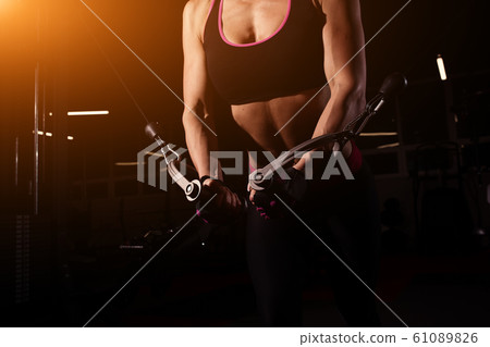 Strong Sporty girl in gym doing exercises Strong Sporty girl in gym doing exercises 61089826