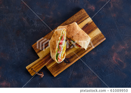 Top view of pita bread stuffed with ham, tomato Top view of pita bread stuffed with ham, tomato 61089950