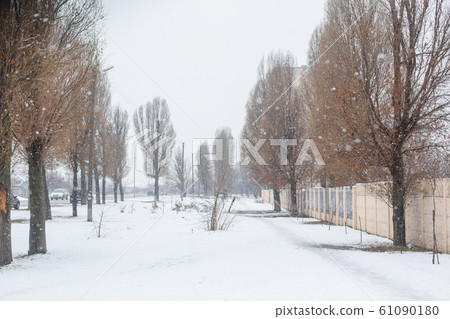 Street covered with snow. Winter in the city. Dirt Street covered with snow. Winter in the city. Dirt 61090180