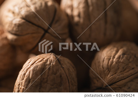 Closeup of inshell walnuts with shallow focus Closeup of inshell walnuts with shallow focus 61090424