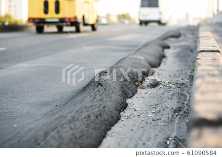 Floating substandard asphalt. Poor quality road a Floating substandard asphalt. Poor quality road a 61090584