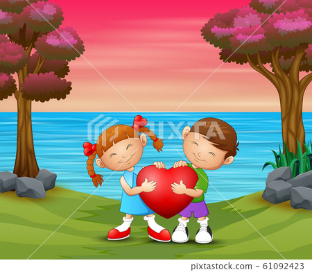 A couple kid holding a heart on nature background 61092423