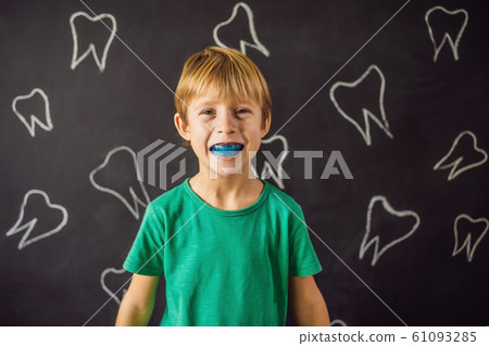 Six-year old boy shows myofunctional trainer. Helps equalize the growing teeth and correct bite Six-year old boy shows myofunctional trainer. Helps equalize the growing teeth and correct bite 61093285