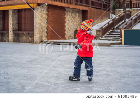 Boy ice skating for the first time Boy ice skating for the first time 61093489
