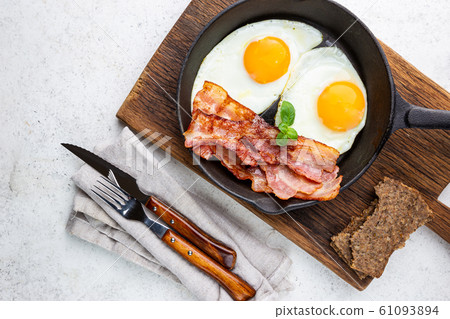 Fried eggs and bacon Fried eggs and bacon 61093894