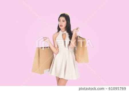 Woman holding shopping bags. 61095769