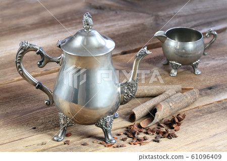 Antique silver teapot, cinnamon and star anise 61096409