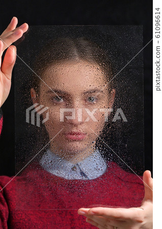 Concept with Girl Standing At The Rainy Window Concept with Girl Standing At The Rainy Window 61096614