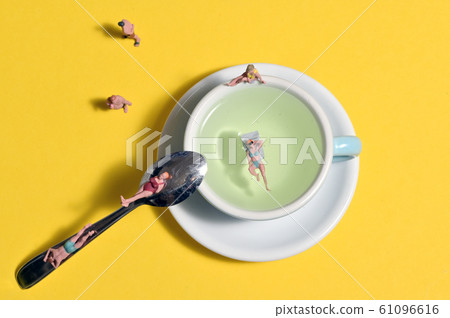 Miniature People Standing On Beach Or Water Slide Miniature People Standing On Beach Or Water Slide 61096616