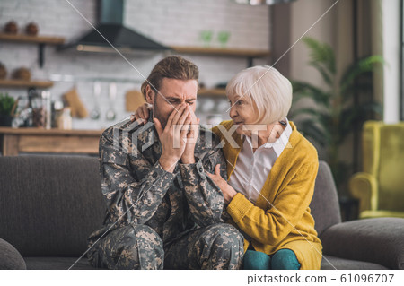 Young handsome man in camouflage looking stressed Young handsome man in camouflage looking stressed 61096707