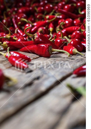 Red hot chili pepper scattered on wooden. Country 61096969