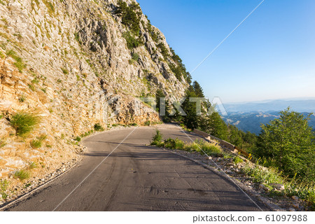 Turn of the road in mountains 61097988