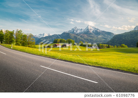Empty asphalt country road with alpine mountain scenery in summer 61098776