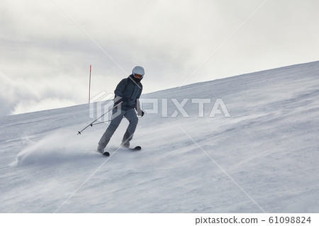 Skiing in the winter snowy slopes Skiing in the winter snowy slopes 61098824