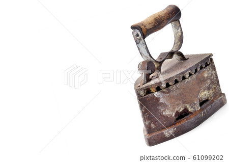Old iron on coals isolated on white background. 61099202