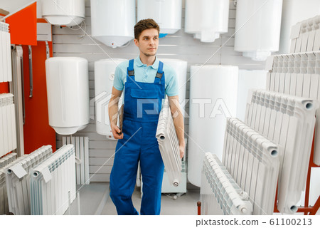 Plumber holds heating radiator, plumbering store Plumber holds heating radiator, plumbering store 61100213