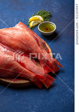 Fresh red sea bass on blue background. Top view, copy space Fresh red sea bass on blue background. Top view, copy space 61103047
