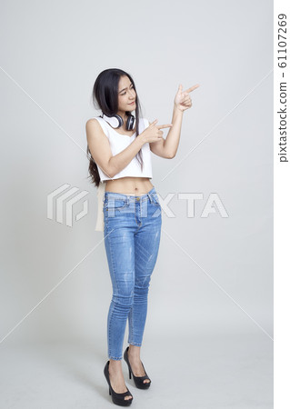 Asian woman wearing headphones dancing active 61107269