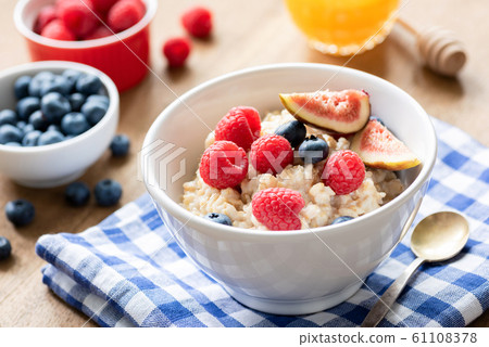 Tasty oatmeal with berries and fruits Tasty oatmeal with berries and fruits 61108378