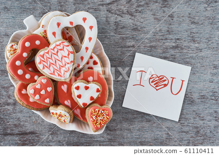Decorated heart shape cookies and paper sheet with inscription i love you Decorated heart shape cookies and paper sheet with inscription i love you 61110411