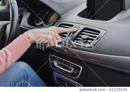 Woman hand press the emergency stop button in the car Woman hand press the emergency stop button in the car 61110538