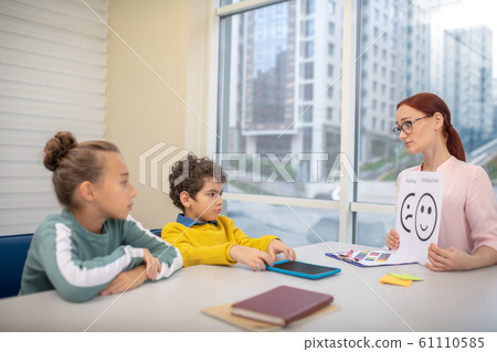 Young teacher using emoji pictures during her lesson Young teacher using emoji pictures during her lesson 61110585