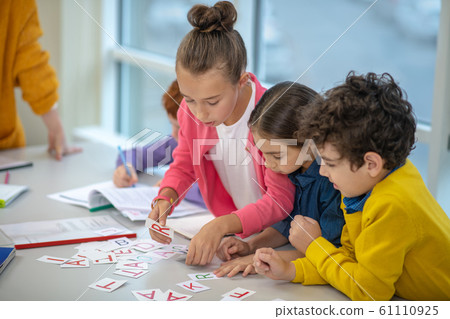Children learning the alphabet while doing interesting tasks 61110925