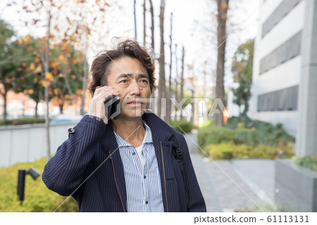 Businessman talking on a smartphone Businessman talking on a smartphone 61113131