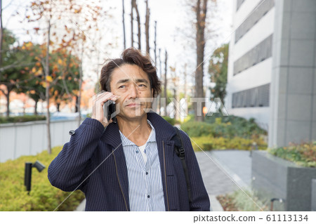 Businessman talking on a smartphone Businessman talking on a smartphone 61113134