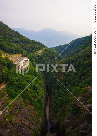 View from the Contra Dam over a hydroelectric power plant in Ticino, Switzerland View from the Contra Dam over a hydroelectric power plant in Ticino, Switzerland 61113216