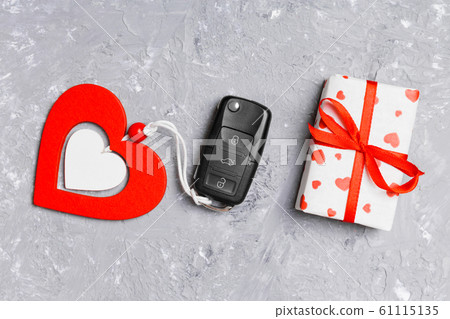 Top view of car key, gift box and heart as a 61115135