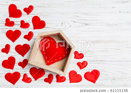 Top view of red heart in a house decorated with 61115136