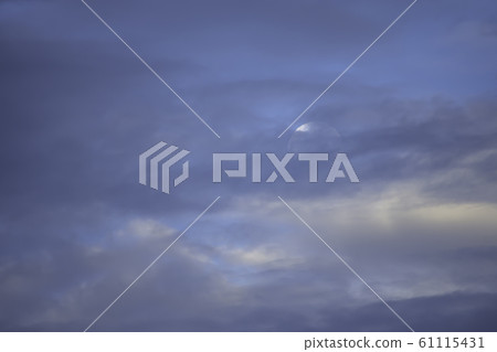 Full Moon on the morning sky behind the clouds. Full Moon on the morning sky behind the clouds. 61115431