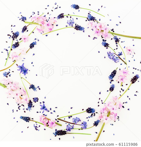 Frame of blue or pink flowers and petals on white background. Flat lay, top view. Frame of blue or pink flowers and petals on white background. Flat lay, top view. 61115986