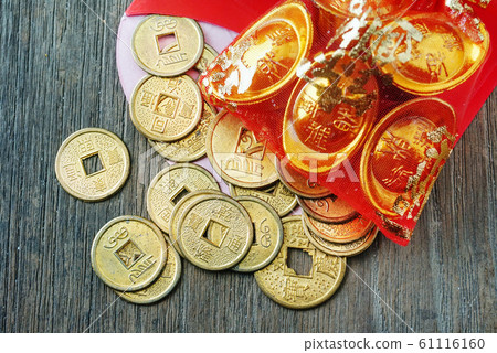 Close up topview coins spread out from red envelope , chinese new year decotation concept. Close up topview coins spread out from red envelope , chinese new year decotation concept. 61116160