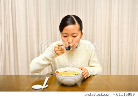 Girl eating New Year's Eve Soba (New Year's Eve) 61116999