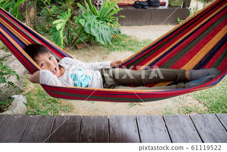 Boy swinging in a hammock Boy swinging in a hammock 61119522